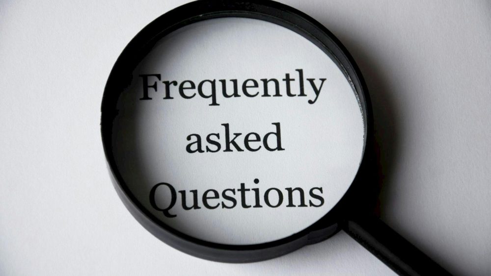 A magnifying glass with the text Frequently asked Question black and white